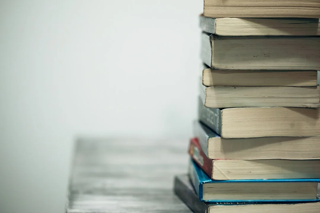 A tall stack of books on a table