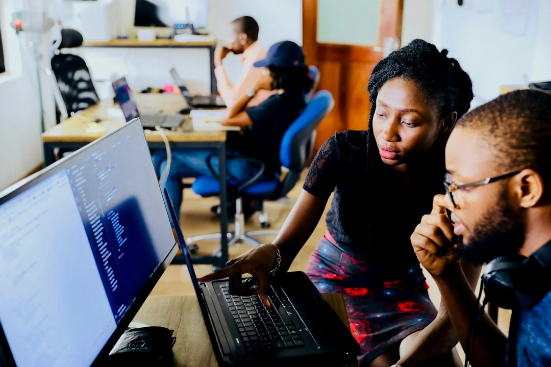 A collaborative discussion around a laptop